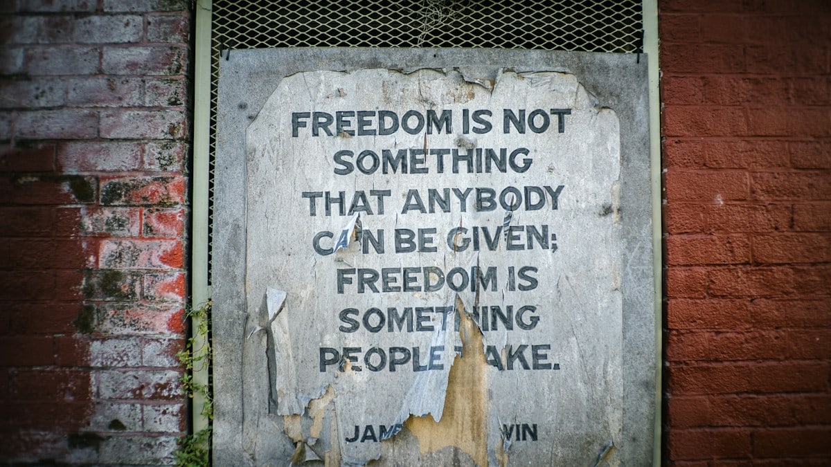 A weathered sign with a quote about freedom